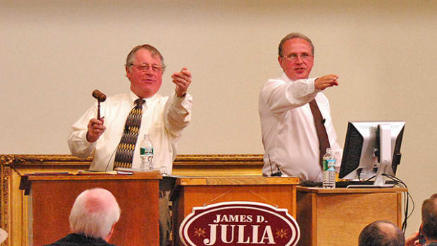 James D. Julia, (left) president and owner of the auction company, along with CEO Mark Ford on the auction block conducting a sale.