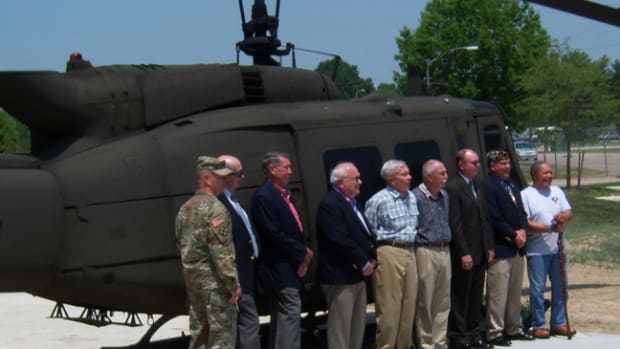 General Williams (on left) poses in front of the UH-1 Huey with some of the Vietnam veterans who were awarded their Vietnam Service pin.