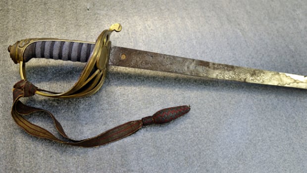  A British-made sword inscribed with initials “RGS” was found in the basement of a Shaw descendent. A Confederate officer had returned the sword to the family after the War. (AP Photo/Elise Amendola)