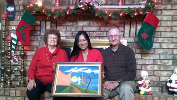 Myrtle Mobley (left), Erika Colligan and Col. Billy Mobley display Erika's father's painting at the Mobley home in Stephenville. Photo by Michael Ross, Empire Tribune