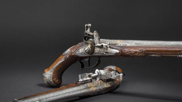  Pair of silver-mounted, chiselled and gilt flintlock pistols, produced circa 1745.