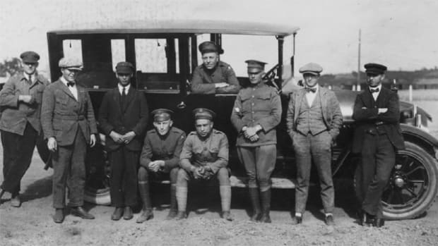  Clive Mason posed with a group of his buddies and co-workers, fourth from the right sitting on the car’s running board. Some of the men who are not in uniform may be either civilian CID agents or German employees of the AFG. With each reduction in assigned “strength,” the AFG hired more local citizens, mainly German Army veterans. They worked as mechanics, quartermasters, and security guards, creating perhaps one of the great ironies of the American occupation: Armed German ex-soldiers guarding the facilities in which the Americans were working and living.
