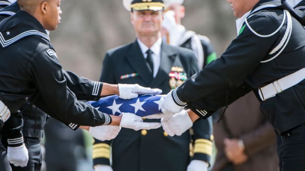  Sailors from The U.S. Navy Ceremonial Guard fold the American flag during the full honors funeral of U.S. Navy Capt. Thomas J. Hudner in Section 54 of Arlington National Cemetery, Arlington, Virginia, Apr. 4, 2018. 