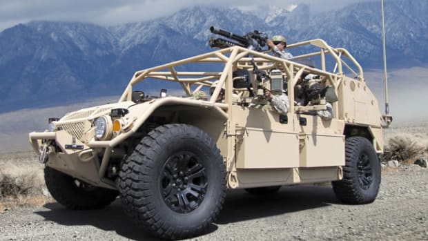  U.S. military off-road vehicle. A GMV 1.1 .with a minigun mounted at the gunner's station. The gunner's mount can transverse a full 360 degrees for all round defense. Note the storage boxes fitted to the doors. Also visibile on the front of a vehicle is a winch for recovery purposes. U.S. DoD Photo.