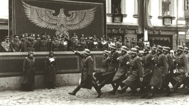  Police formations march past dignitaries in Krakow, including Heinrich Himmler and Hans Frank. When dressed for such occasions, some German NCOs and enlisted soldiers would wear brass or wood handled “dress” bayonets decorated with colored tassels that designated their individual units.