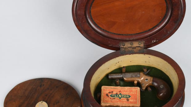 Novel 1850s wood sewing case with pincushion top that opens to reveal beneath its false bottom a 4-inch-long, .22-caliber Derringer. Sold for $1,920, nearly four times the high estimate