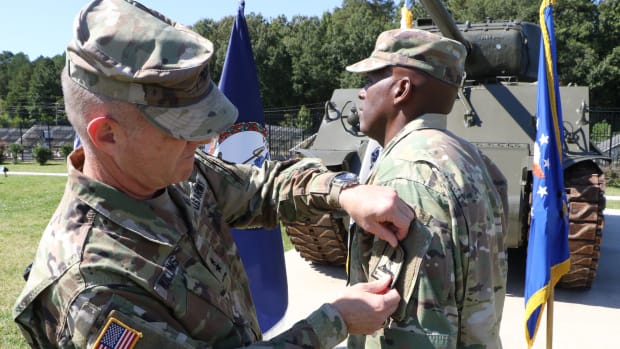 MG Timothy Williams places the new VANG JF HQ patch on the left sleeve of Command Sergeant Major Ronald Smith at the  September 28, 2021, ceremony.