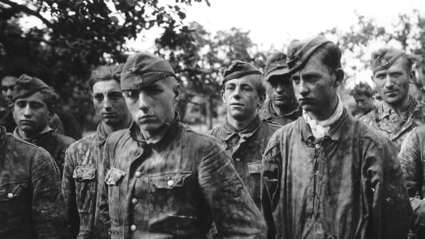Vintage photo of captured, young Waffen SS members wearing dot camouflage