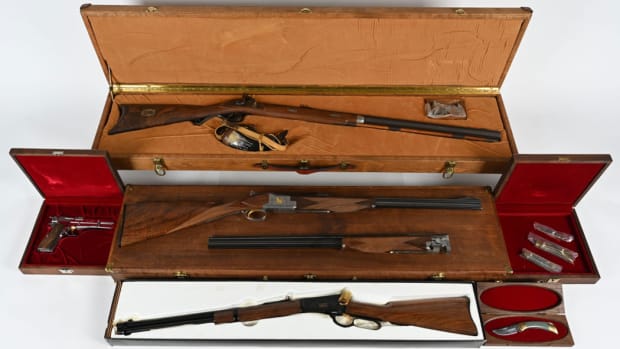Complete Browning Centennial Set consisting of the Centennial Express superposed shotgun/rifle combination with 30-06 and 20-gauge barrels; a nickel-finished Belgian high-power 9mm pistol, a Browning Model 92 lever-action 44 mag rifle with special gold inlay, and John Browning .50 caliber black powder rifle with matching serial-numbered powder horn. Alderwood presentation case. Also, set of three serial-numbered Browning knives in matching presentation cases and another matching-numbered Wyoming Great Divide commemorative knife. All items serial-numbered 0148 of 500. Modern set in extremely fine to new condition.
