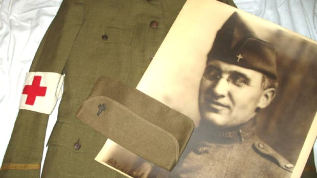 The large U.S. Signal Corps portrait of Father Arthur A. LeMay was purchased more than thirty years ago at a VFW tag sale for $1. The portrait reunited with LeMay’s tunic and overseas cap in 2008.
