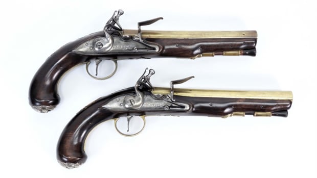 A Pair of English silver and brass mounted flintlock pistols from around 1760, both 13 inches in length including the barrel, to be sold together as one lot.