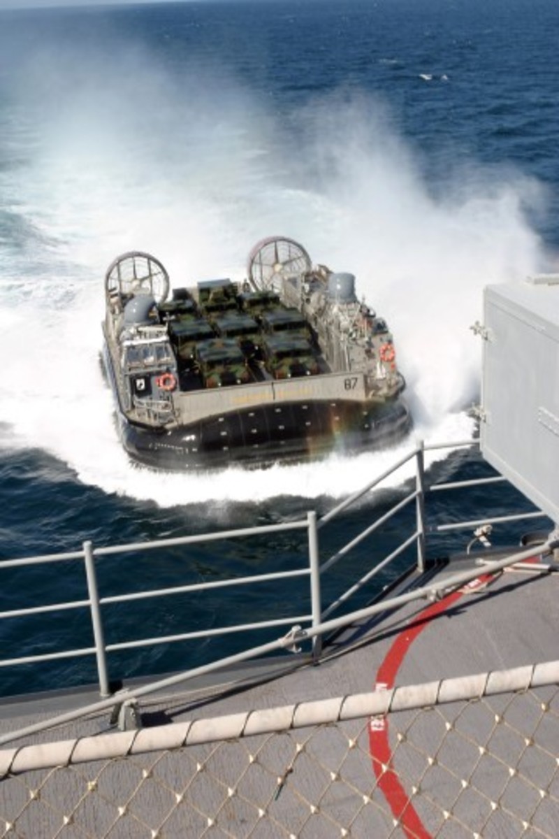 The Landing Craft Air Cushioned (LCAC) is not what one would think of as a traditional amphibious vehicle. Rather than wheels or tracks, the vehicle rides ashore on a cushion of air. Moving at 40 knots, the gas turbine powered vehicle can quickly put huge amounts of personnel and materiel ashore.