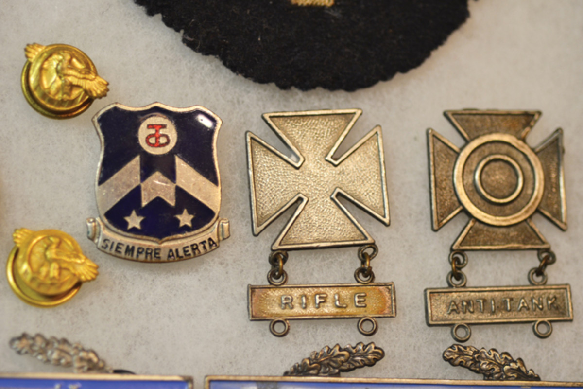  This close up view shows marksmanship qualifications and his unit affiliation with the 357th Infantry regiment.