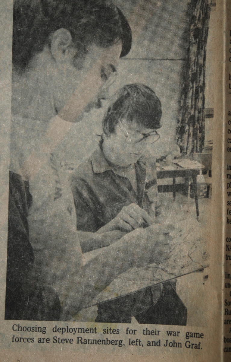 Yeah, that's me in 1981, wearing my "lucky 1st Cav" shirt and going over unit disposition with a fellow gamer (and actual National Guard member).