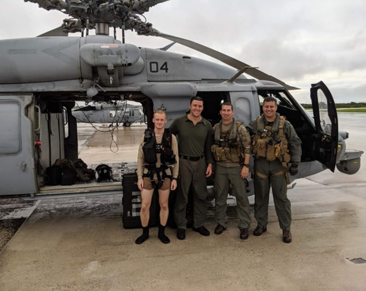  Photo Caption: Photo By Petty Officer 2nd Class Kirsten King | ANDERSEN AIR FORCE BASE, Guam (July 24, 2019) (From Left to Right) Naval Air Crewman (Helicopter) 2nd Class Preston Smith, from Stevens Point, Wisconsin, Naval Air Crewman (Helicopter) 2nd Class Dominic Thomas, from Menominee Falls, Wisconsin, LT Nathan Gordon, from Marietta, Georgia, and LTJG Caleb French from, Amherst, Wisconsin, pose for a photograph after completing a search and rescue mission as part of “Island Knights” of Helicopter Sea Combat Squadron (HSC) 25. HSC-25 provides a multi-mission rotary wing capability for units in the U.S. 7th Fleet area of operations and maintains a Guam-based 24-hour search-and-rescue and medical evacuation capability, directly supporting U.S. Coast Guard and Joint Region Marianas. HSC-25 is the Navy’s only forward-deployed MH-60S expeditionary squadron. (U.S. Navy photo courtesy of HSC-25)