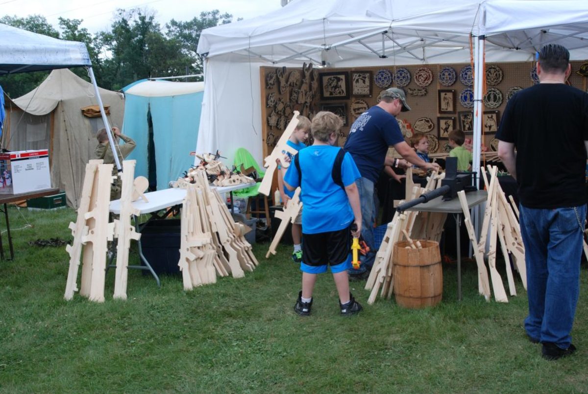Cut from soft, 1" thick boards, a variety of "weapons" await new armies of imaginative young people at the Iola Miltary Show. 