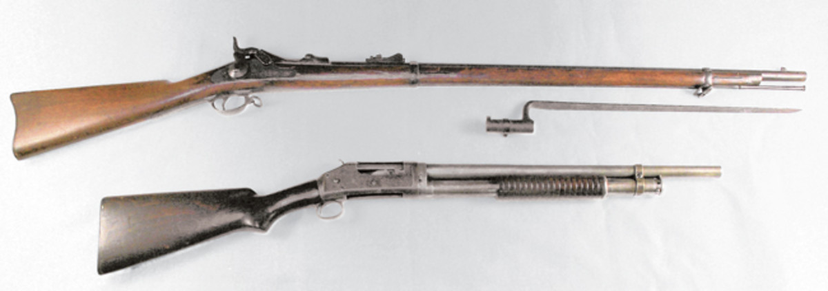  A Springfield trapdoor 45/70 rifle documented to have been used in the Philippines is pictured at the top. The Winchester Model 97 riot gun (bottom) also used in the Philippines.