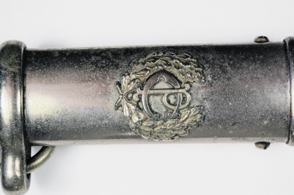  Constabulary sword scabbard showing “PC” in wreath at throat of scabbard.