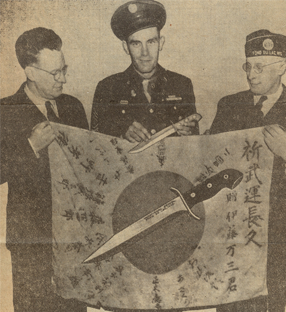 An old newspaper clipping shows Otto J. Dorr, then Director of the Fond du Lac Vocational School, Sgt. Jeske of the 32nd Division, and Clarence Fenner, Commander of the American Legion post.