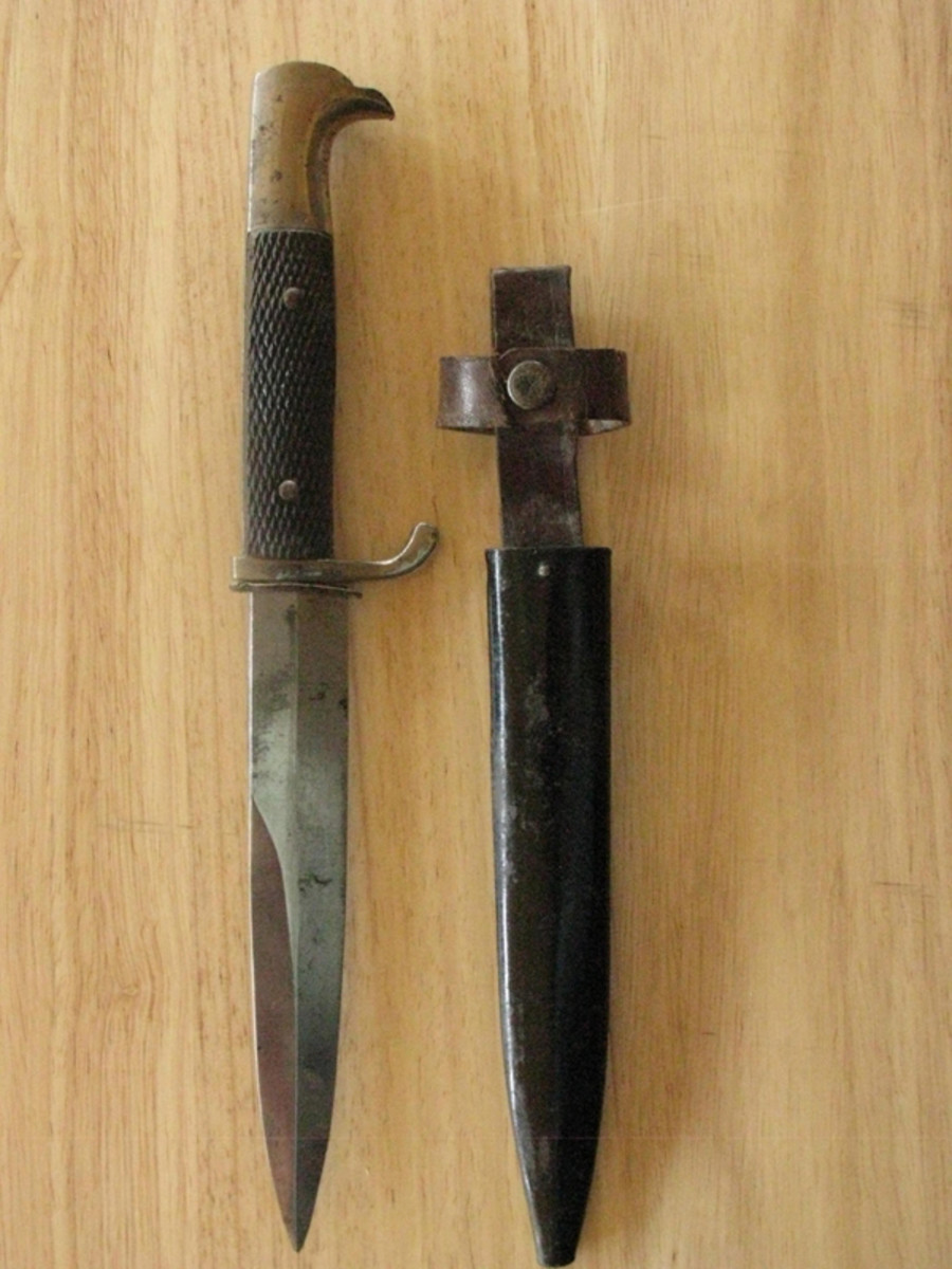  This double-edged German weapon is topped with an eagle pommel and checkered wooden grips
