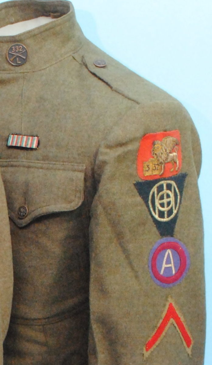  The triple-decker stack of patches from the uniform service coat belonging to Elmer Thompson, a Doughboy serving in Company “L” of the 332nd Infantry Regiment.