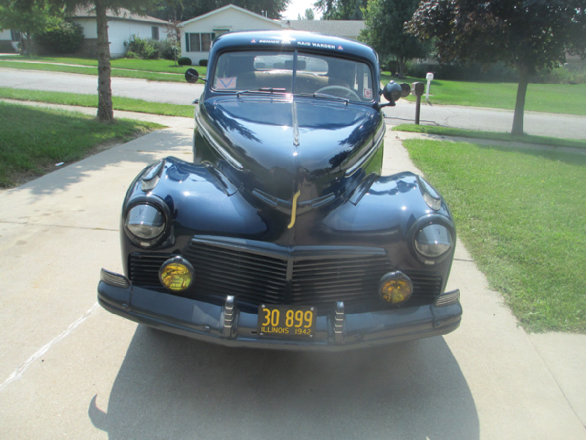 The fog lights, spot light, and windshield decals are all correct for a Civilian Defense car in 1942.