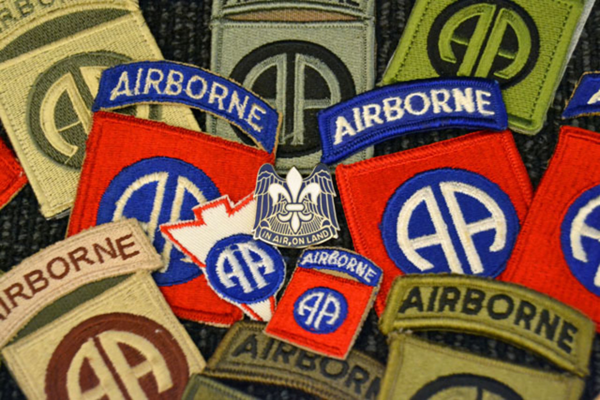 Variations of 82nd Airborne Division patches from World War II to present surrounding the division headquarters unit crest which was approved on 23 October 1942. The fleur-de-lis is representative of the division’s battle honors earned in France during World War I. The wings are symbolic of the Division’s mission as is the motto.