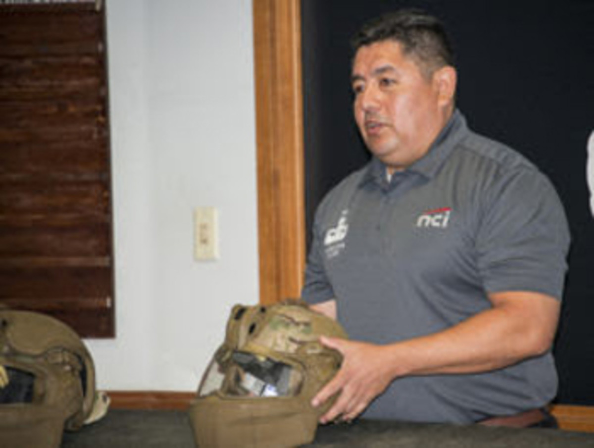  Bobby Salazar, from Program Manager Soldier Protection and Individual Equipment, out of Fort Belvoir, Virginia, discusses proper fitting of the new Integrated Head Protection System (IHPS) during New Equipment Training. (Photo by Michael Zigmond, Audio Visual Production Specialist, Airborne and Special Operations Test Directorate, U.S. Army Operational Test Command)