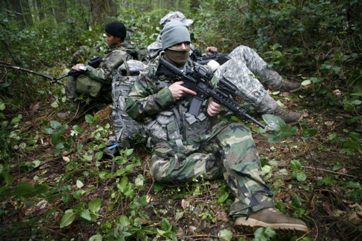 Phil Sussman Pvt. Nicholas Klusener sits with his team at a hide site, May 13, during the LRS Company FTX.