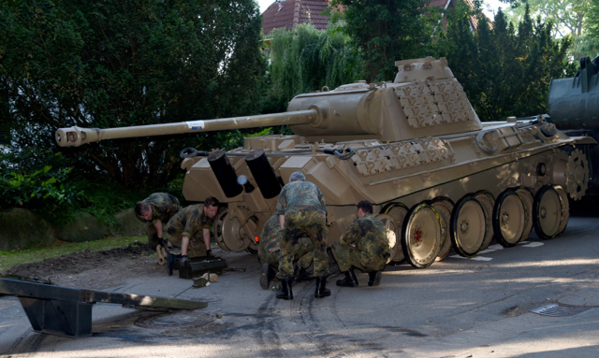 In this July 2, 2015, picture a World War II -era Panther tank is prepared for transportation from a residential property in Heikendorf, northern Germany. Authorities have seized a 45-ton Panther tank, a flak canon and multiple other World War II-era military weapons in a raid on a 78-year-old collector's storage facility in northern Germany. 