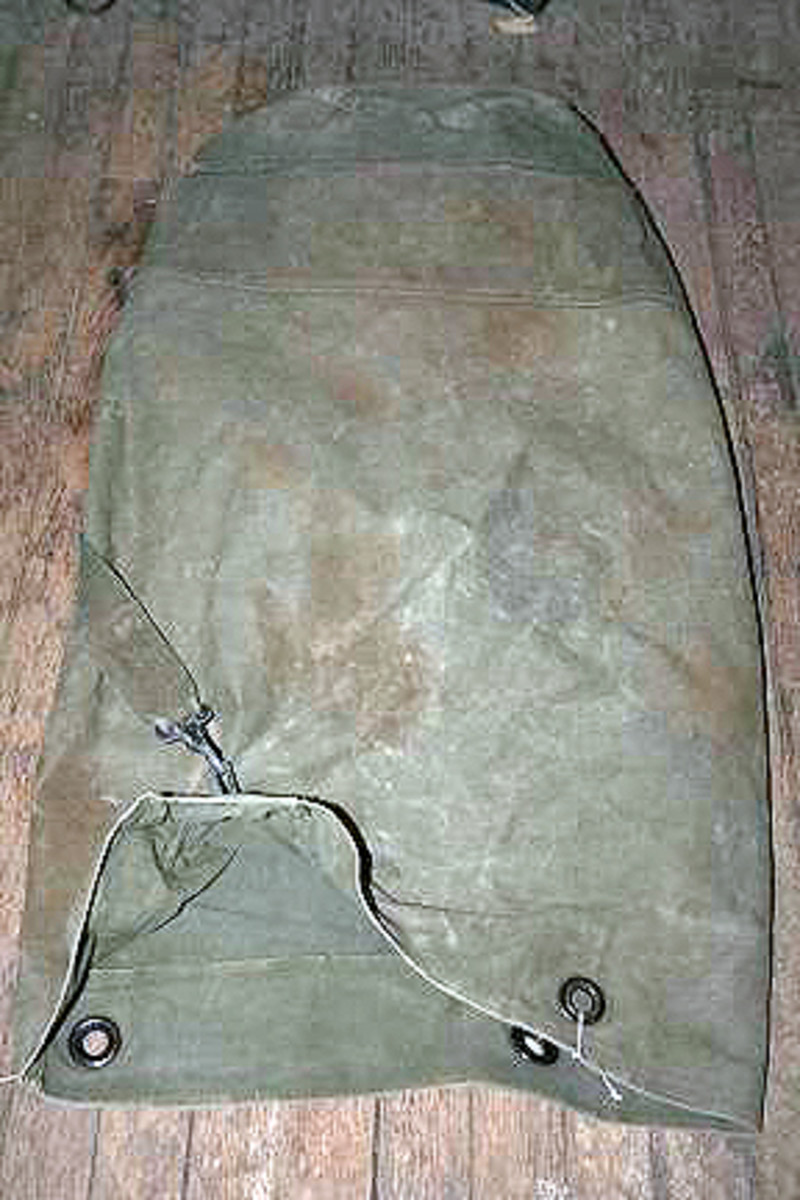 Lot #112. Seven military bags and blanket.