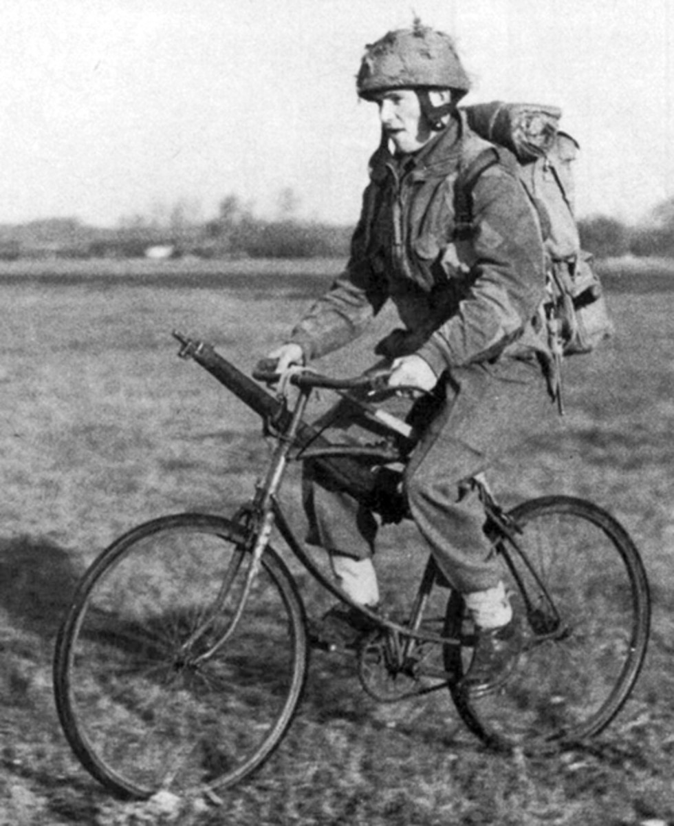  Often overlooked by many collectors, two-wheeled bicycles have played important roles in combat since before WWI. Here, a WWII British paratrooper uses a BSA folding-bicycle as an alternative to walking.