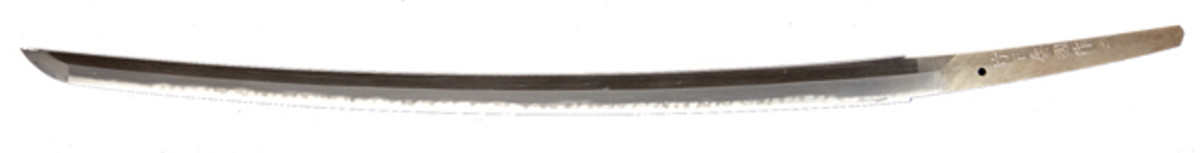The Yasukuni smiths were among the most important makers of Japanese swords in the World War II era. Among them was Takeshita Yasukuni, maker of this sword in Hokaido in 1943. It is large, heavy and long (27 inches) for the period and has a complex hamon. This smith’s swords appear in civilian or non-military mountings as well as military ones. The large size and style of some of his swords resemble work from the 15th century.