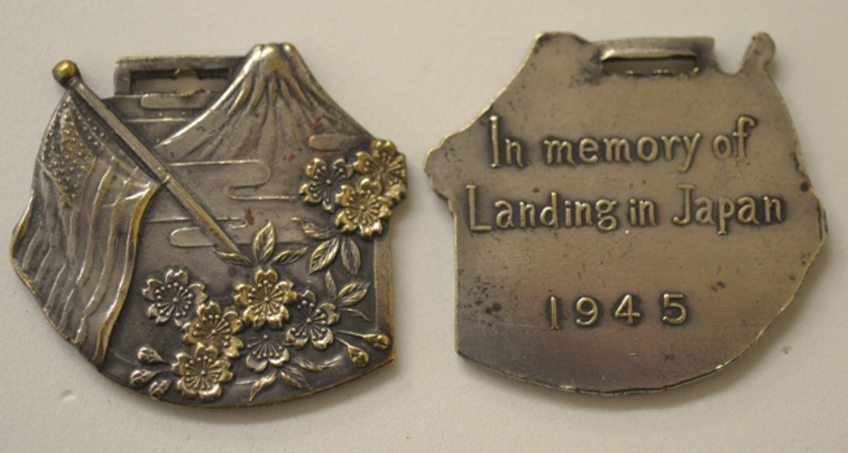 One of the early Japanese Occupation souvenir medals is rectangular and depicts Mt. Fuji and cherry blossoms.