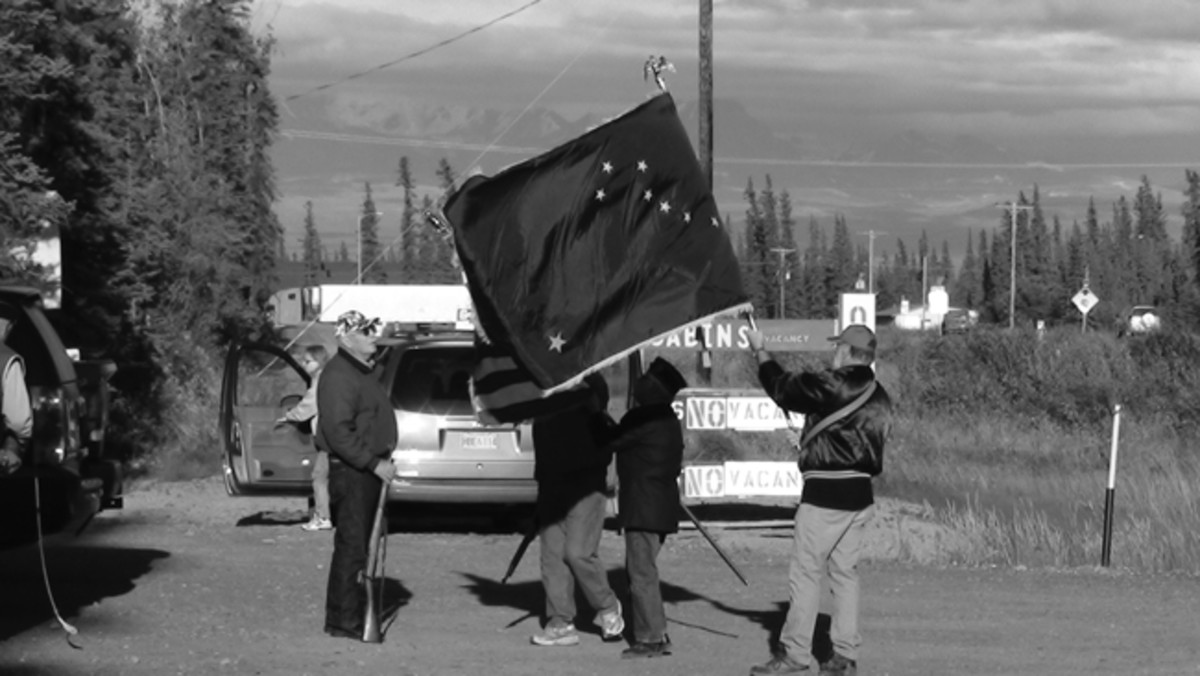  This photo evidence of Murphy at work was taken during the 2012 MVPA Alaska Highway convoy. The local veterans color guard was preparing for community pot luck and event ceremony at a small town when my son Gunnar asked the flag bearer if the North Star was “down there.” Murphy had turned the State Flag upside down. Photo by Gunnar Sigrist