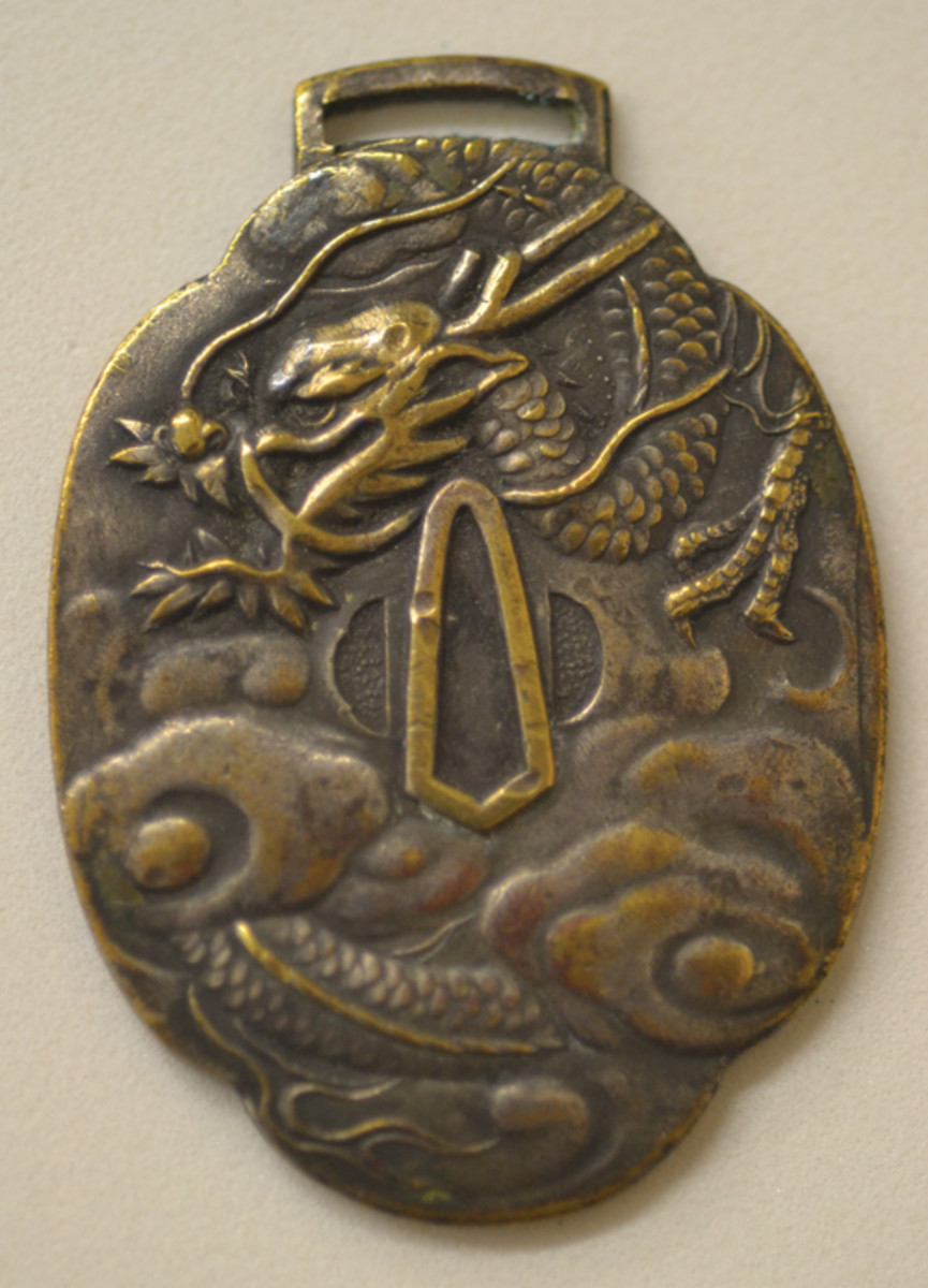 The theme on this oval shaped souvenir medal is an early design with the addition of the familiar, “In Memory of Landing in Japan.”