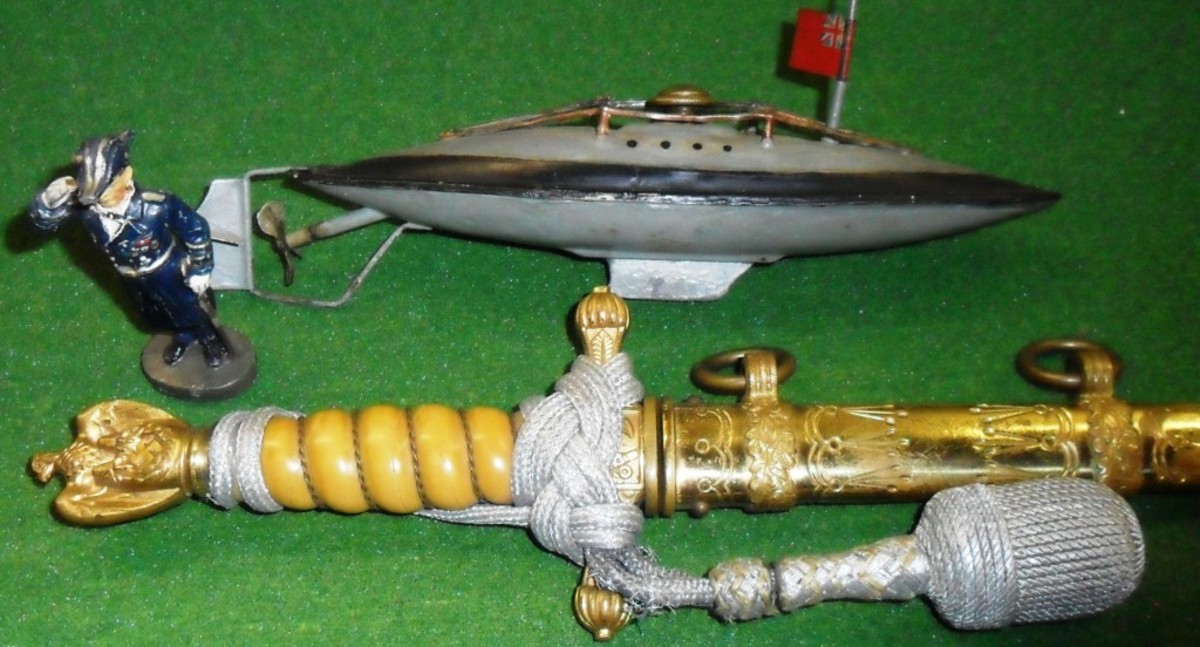 Vintage military toys can be great complements to a display of authentic relics such as this WWI-era Marklin toy submarine and a 1930s Elastolin toy of Admiral Raeder displayed with a WWII German Navy dagger.