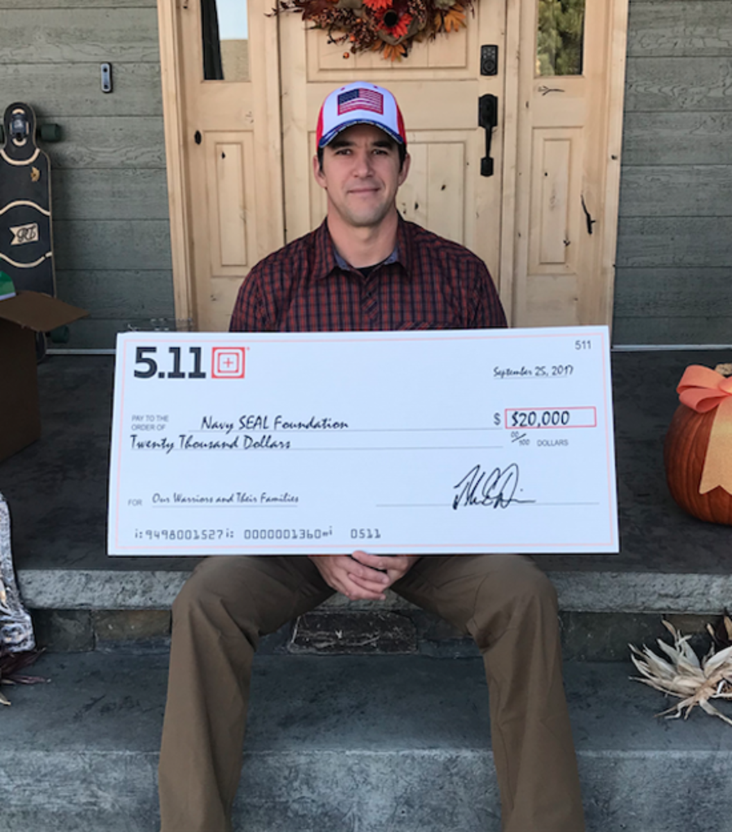  Andy Stumpf holding the $20,000 check from 5.11 to Navy SEAL Foundation