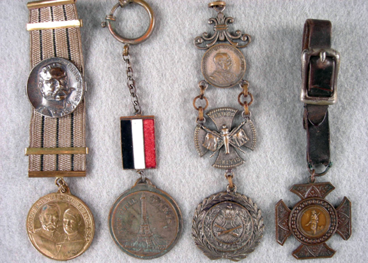 Who was the German soldier who had “Besetzung von Paris 14 Juni 1940 FR” (Occupation of Paris) inscribed on the reverse of the souvenir Eiffel Tower fob during WWII? The Spanish American War fob (far right) has the Lord’s Prayer on the reverse of the center coinage. (left to right) Paul von Hindenburg & Adolf Hitler patriotic fob 1933; German occupation of Paris WWII; Austrian Artillery Officer 1900s; Spanish-American War with Lord’s prayer on reverse.