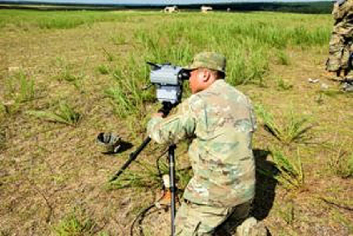  Pvt. 1st Class Preshelemiah Hitgano, of Headquarters and Headquarters Battery, 2nd Battalion, 319th Field Artillery Regiment, sets up the Joint Effects Targeting System (JETS), to check that it functions after airdop testing at Fort Bragg, N.C. JETS testing will continue into 2018 at several military installations. (U.S. Army file photo)