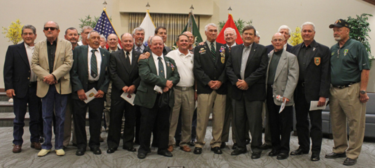 Retired Army Master Sergeant Patrick Watkins Jr., front row, third from right, stands with fellow veterans of the Military Assistance Command, Vietnam – Studies and Observations Group after being presented with the Distinguished Service Cross. Watkins was awarded the nation's second highest military honor in a ceremony May 22 in the 7th Special Forces Group (Airborne) Chapel.