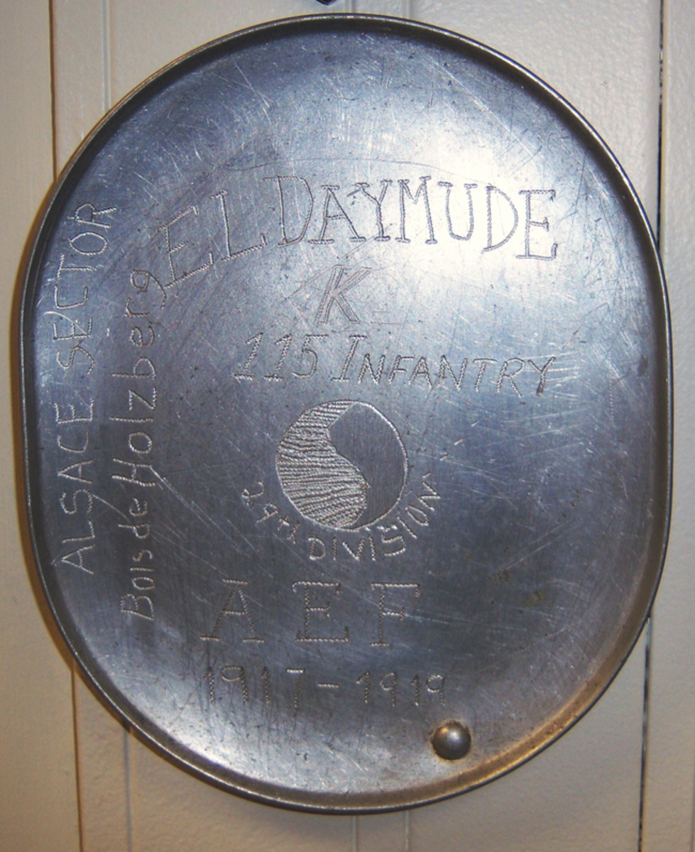  The inside of the mess kit could also serve as a canvas. Here a Maryland Doughboy from the 115th Infantry Regiment has carved his name and unit information. Of note is his carving “Bois de Holzberg” on the side. This may reflect the German trench raid on 31 July 1918 at the Bois de Holzberg that caused the 115th’s first combat casualties of the war. They would not be the last.