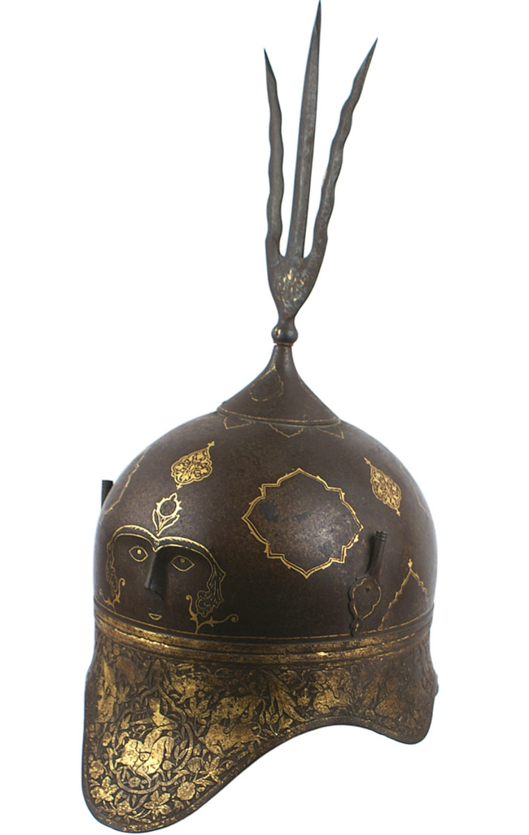  Unusual circa 17th century Indo-Persian helmet, bowl-shaped and profusely chiseled with gold washed figures.