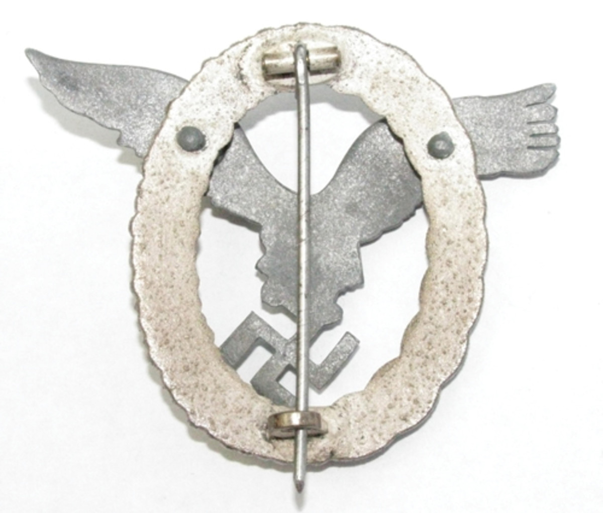  The reverse of a pilot’s badge shows the rivet heads, and attaching pin and “C” hook.