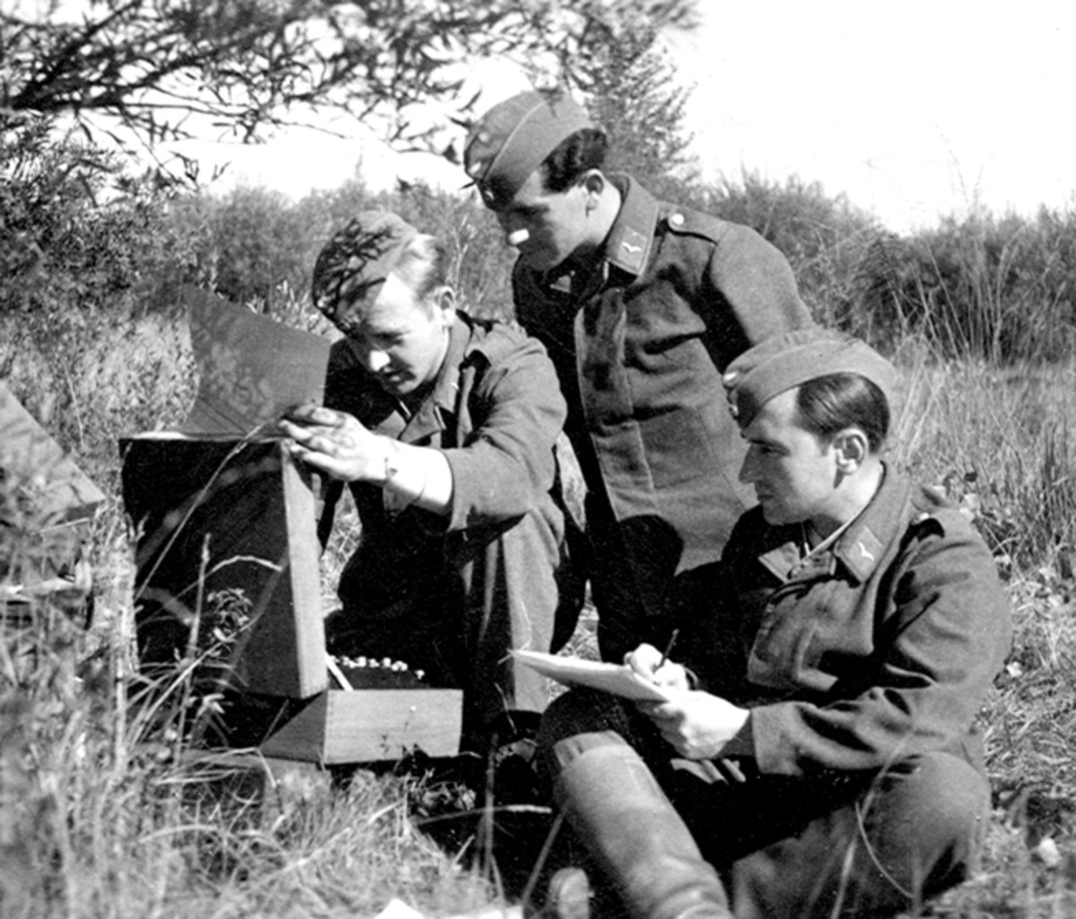 Luftwaffe troops use an Enigma machine. One man types while another records the enciphered or deciphered letters. (Photo courtesy of Helge Fykse, Norway)