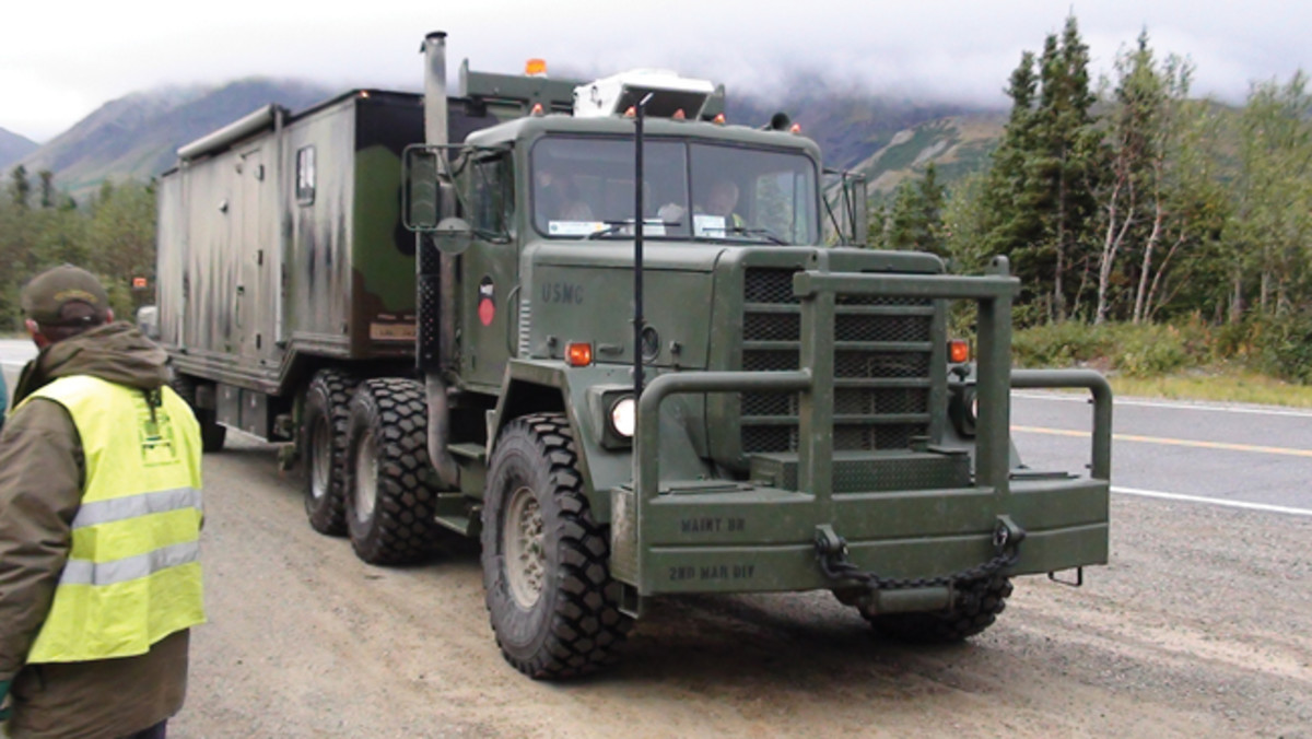 Modifications to this AM General M915A1 on the 2012 Alaska Highway Convoy included bumper/grill, air conditioning, and 16:00 tires. Various M373A3 trailer modifications included different axle with air bags, camper conversion with all the conveniences, and tool and parts storage. Ken Field has driven this rig more than 95,000 miles during the past 7 years.
