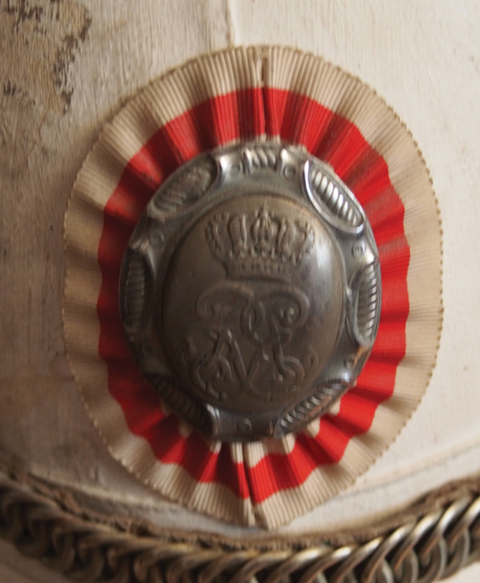 The white/red/white cockade of Monaco adorns headdress and helmets of the tiny nation’s military dress uniforms.