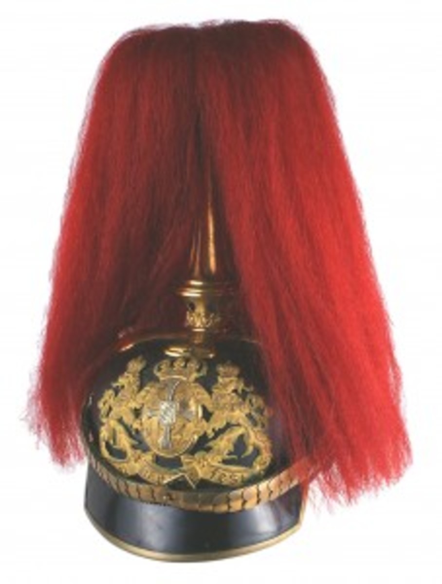 Another Imperial German helmet – a Bavarian Artillery Regiment officer’s parade helmet, also with an excellent solid black leather body – breezed to $3,120. The age toned large Bavarian crowned coat-of-arms showed a pair of lions holding the state arms (with “In treue Fest”) on the front plate. Other features included silk lining, gilt brass convex chin scales and red parade bush.