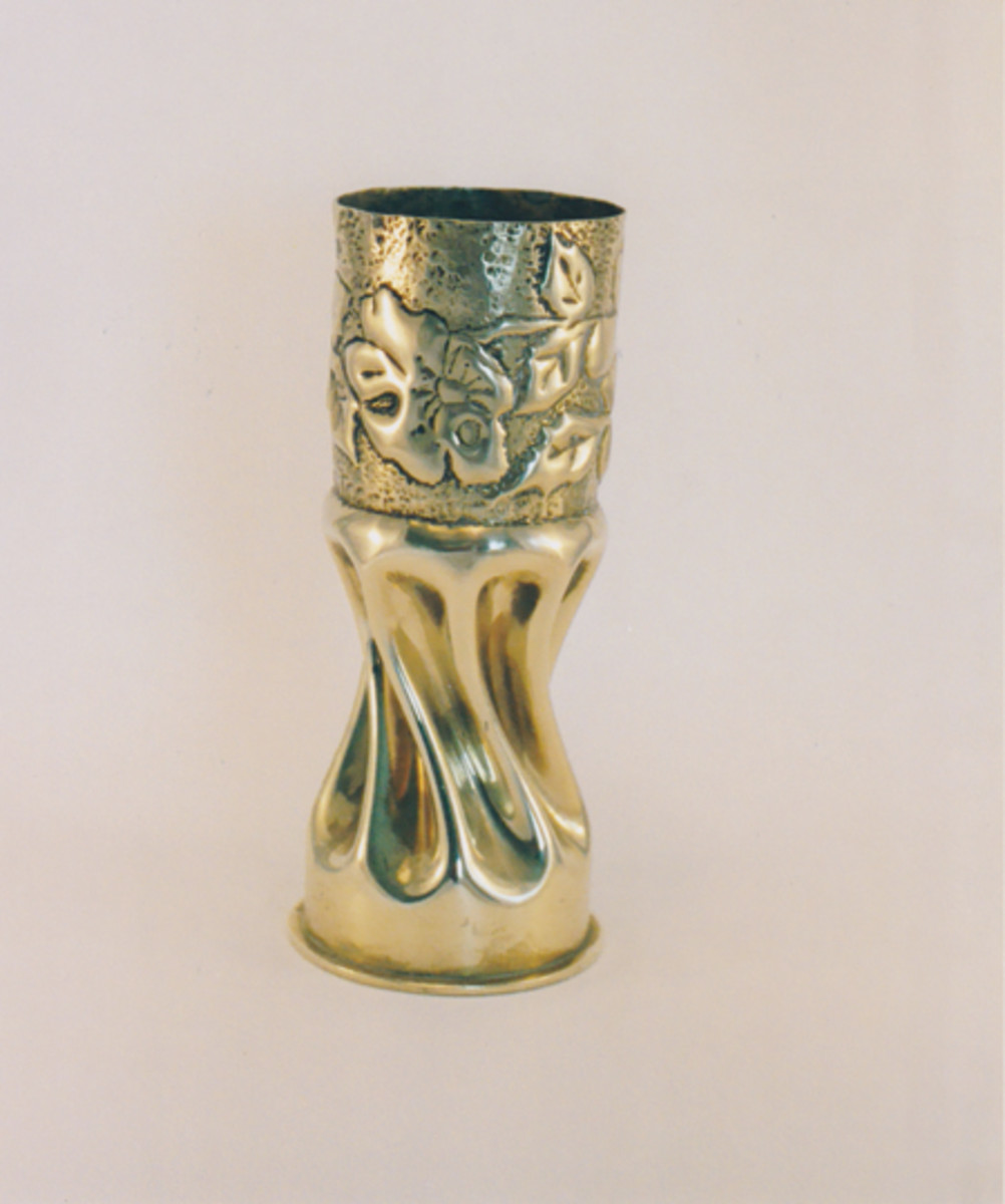  Fluted and twisted vase with irregular embossed background. World War I trench art made from artillery shell. Claire Luisi, www.trenchartcollection.com