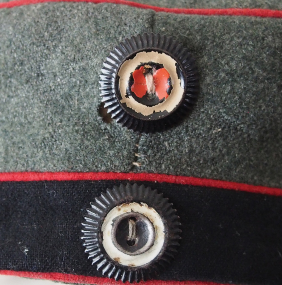 The sewn on style “Kokarden” worn on the World War I field caps. As with other Imperial German headdress the Reich cockade was worn above the state cockade – in this case Prussian on a field cap for an artillery soldier.
